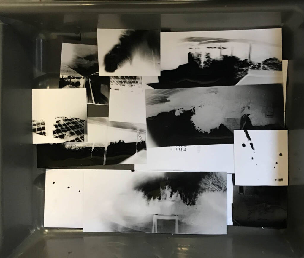 Black and white artistic photography sits in a black plastic basin